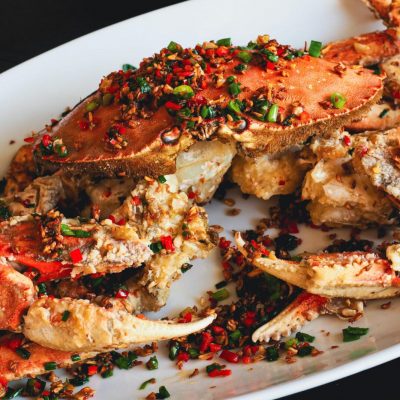 Cooked crab with red and green pepper flakes
